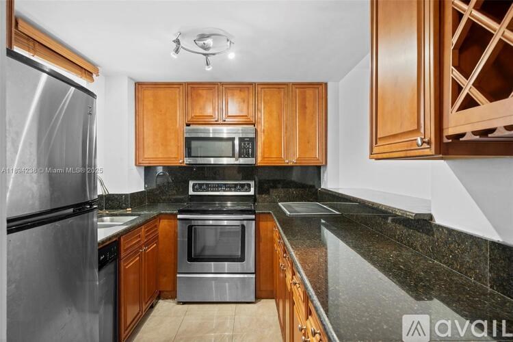A kitchen with wooden cabinets and granite countertops.