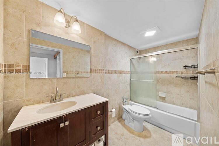 A bathroom with a sink, toilet, and bathtub.