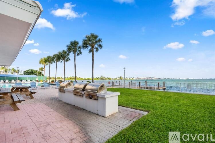 A sunny day at the beach with palm trees and a clear blue sky.