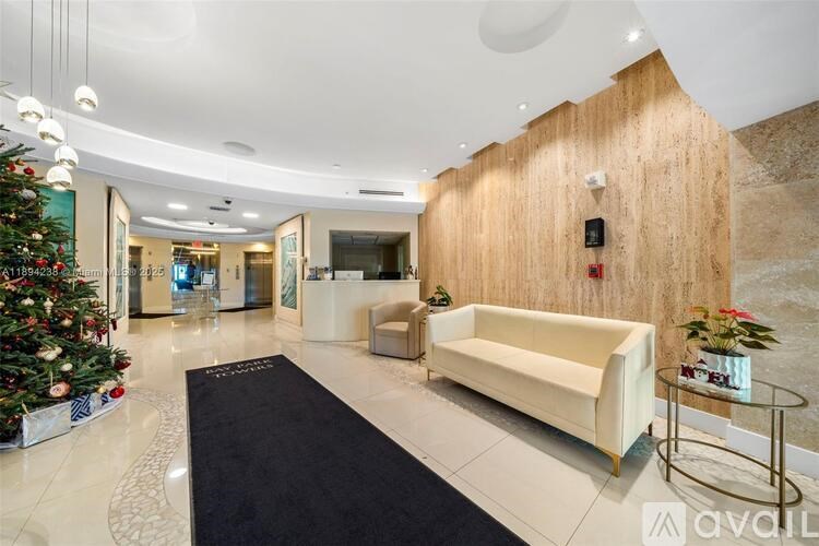 A Christmas tree is decorated with red and white ornaments and lights.