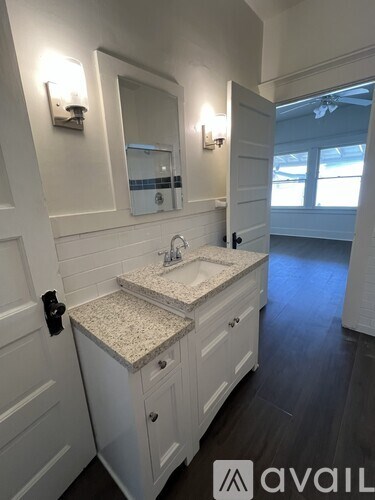 A bathroom with a sink and mirror.