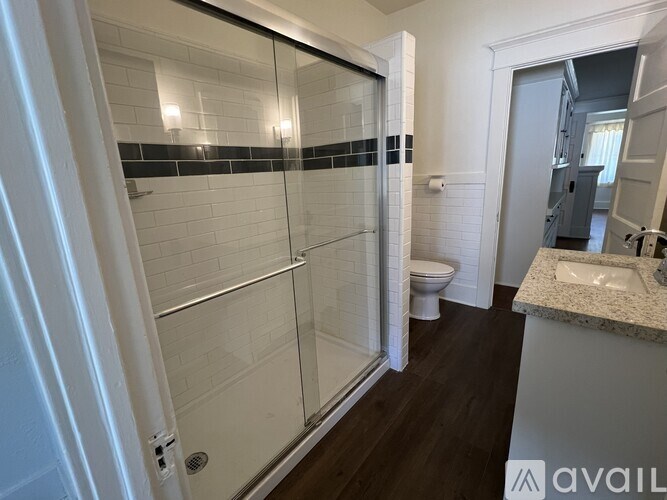 A bathroom with a walk-in shower and a toilet.