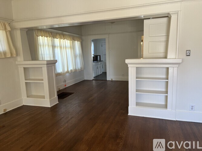 A living room with a fireplace and a television.