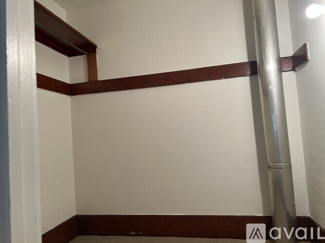 A room with white walls and a brown trim.