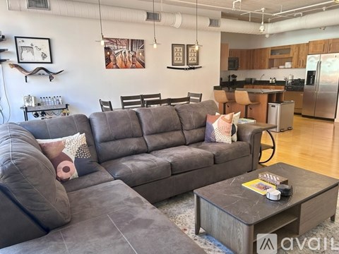 A living room with a grey sofa and a coffee table.