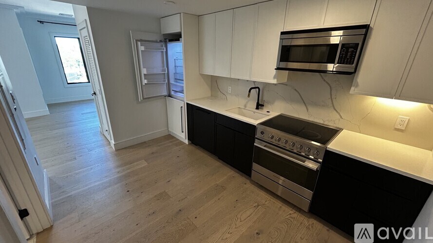 A kitchen with a stove top oven and microwave above it.