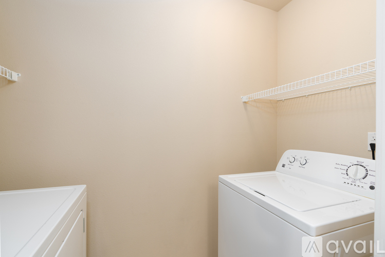 A white washing machine in a laundry room.