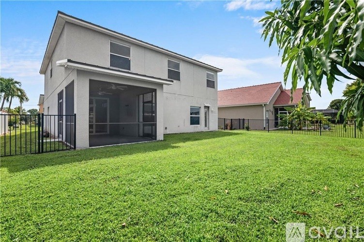 A modern house with a large front yard is for sale.