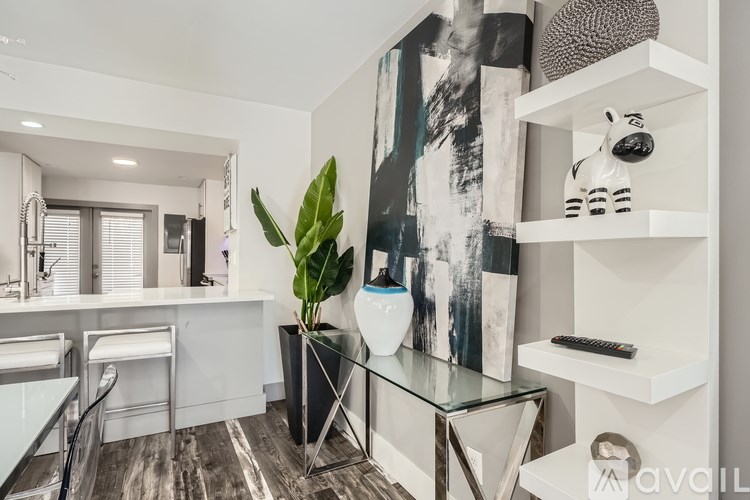 A bathroom with a glass table and a white chair.
