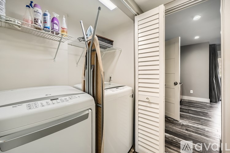 A small laundry room with a washer and dryer.