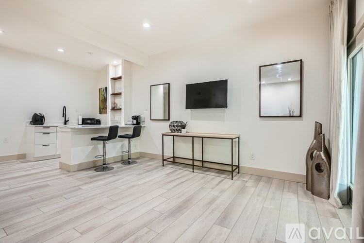 A modern kitchen with a dining table and chairs.