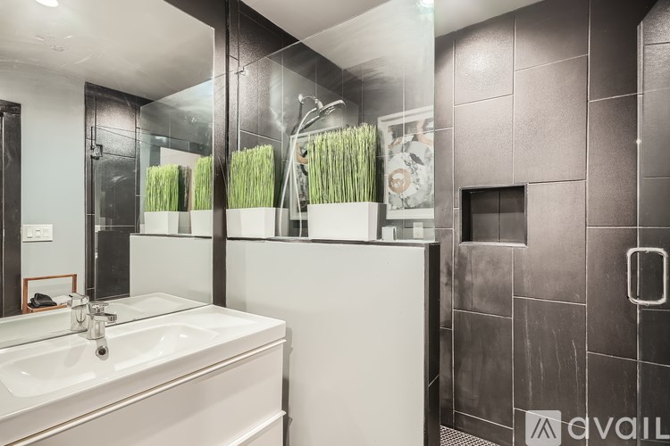 A bathroom with a white sink and a mirror.