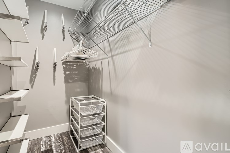 A storage room with shelves and bins.