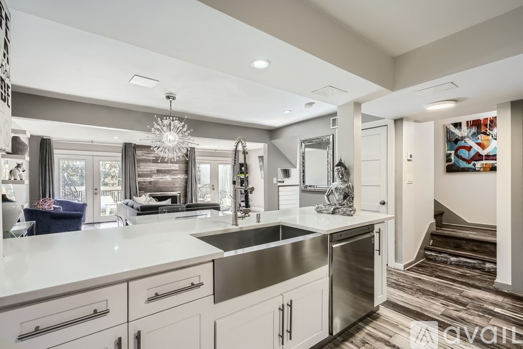 A modern kitchen with a large island and stainless steel appliances.