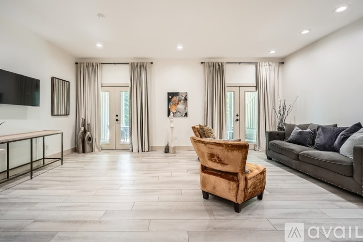A living room with a brown chair and a grey couch.