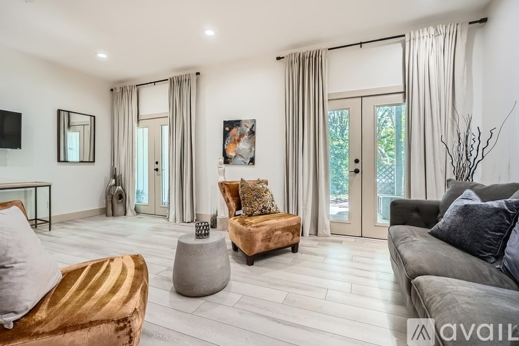 A modern living room with a gold sofa and grey couch.