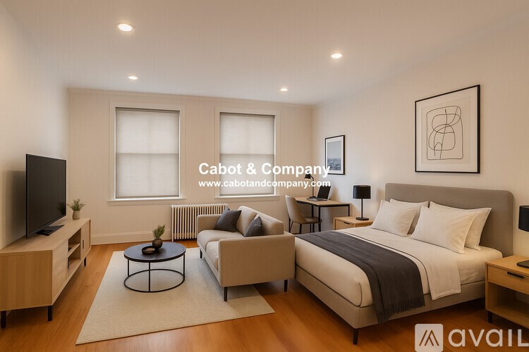 A modern bedroom with a large bed, a television, and a coffee table.