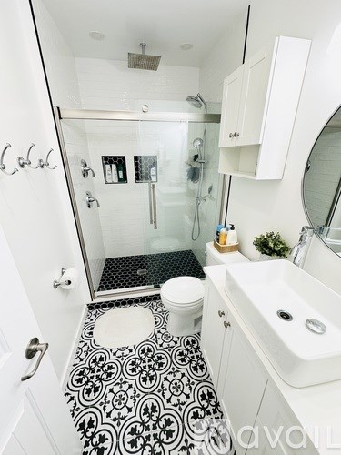 A bathroom with a black and white floor.