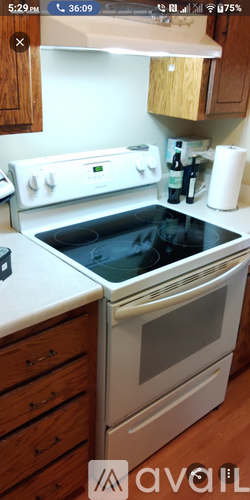 A white oven with a glass door is in a kitchen.