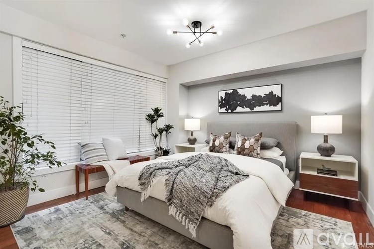 A bedroom with a large bed and a ceiling fan.