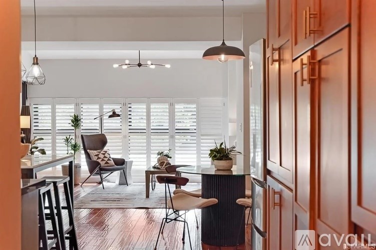 A modern dining area with a glass table and chairs.