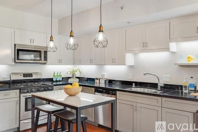 A kitchen with a table and chairs in front of a stove and oven.