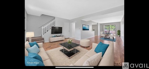 A living room with a white couch and a coffee table.