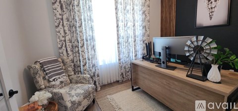 A living room with a television and a chair.