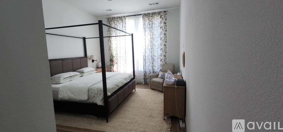 A bedroom with a large bed and a smaller bed in the corner.