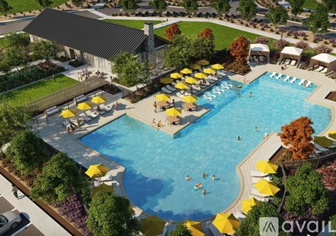 A large outdoor swimming pool surrounded by yellow umbrellas and people enjoying the water.