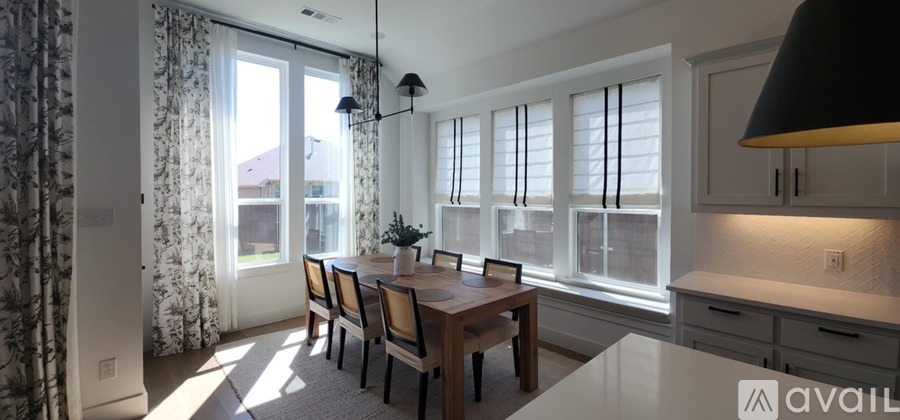 A dining room with a table and chairs is available for rent.