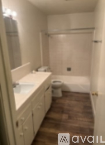 A bathroom with a toilet, sink, and bathtub.