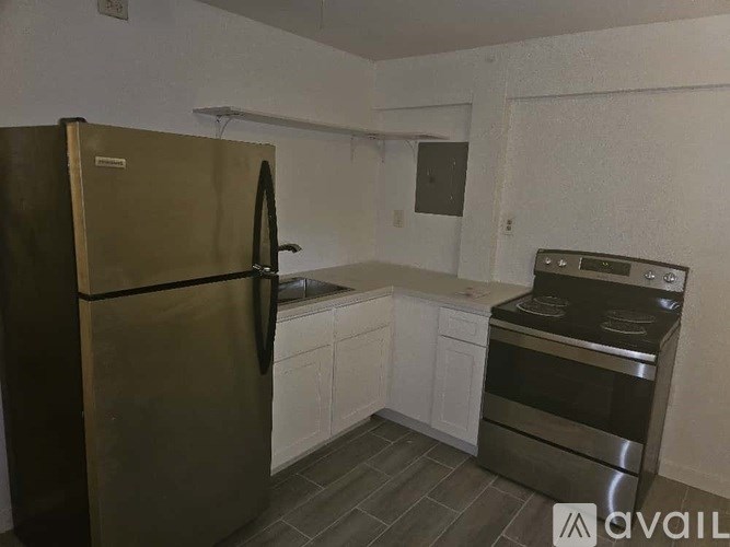 A kitchen with a stainless steel refrigerator and an oven.