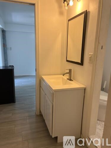 A bathroom with a sink and mirror.