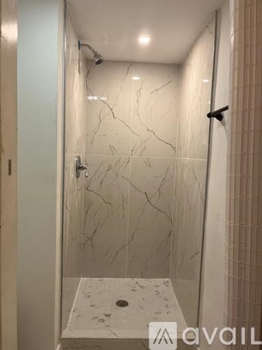 A bathroom with a marble floor and wall.