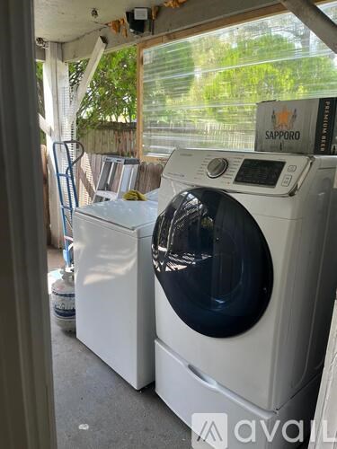 A white washing machine is in front of a dryer.