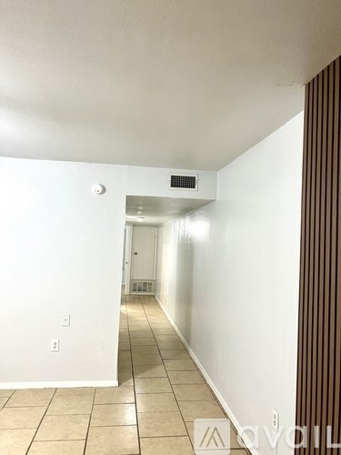 A long hallway with a door at the end.