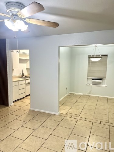 A room with a ceiling fan and a light hanging from the ceiling.