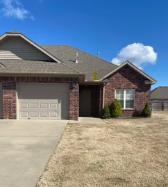 A house with a brown roof and a white garage door.