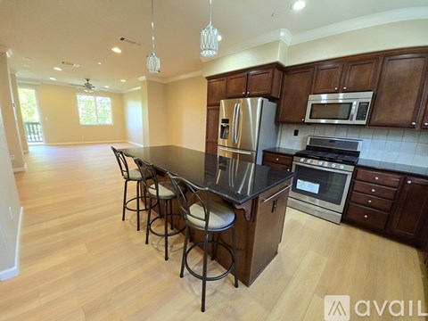 A kitchen with wooden cabinets and a black countertop.