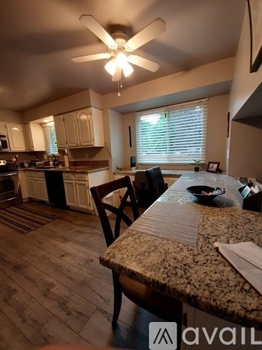A kitchen with a table and chairs in the foreground.