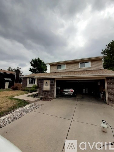 A house with a garage and a car inside.
