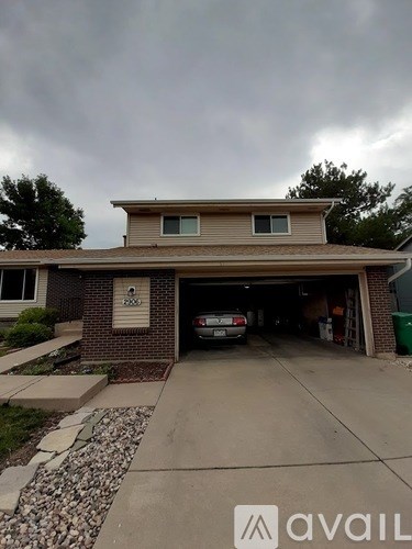 A house with a car in the garage.