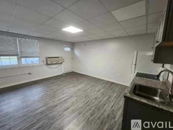 A kitchen area with a sink and a window.