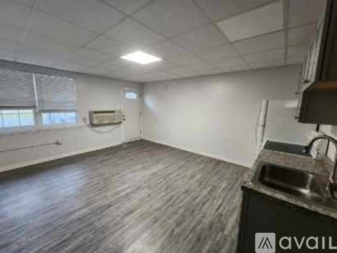 A kitchen area with a sink and a window.