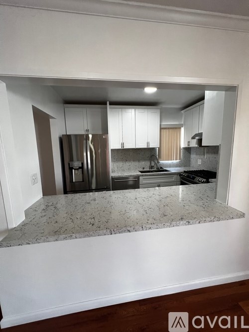 A kitchen with granite countertops and stainless steel appliances.