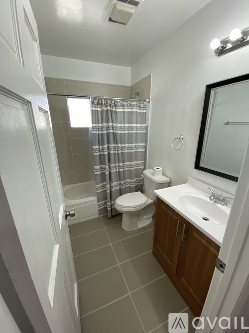 A bathroom with a toilet, sink, and shower.