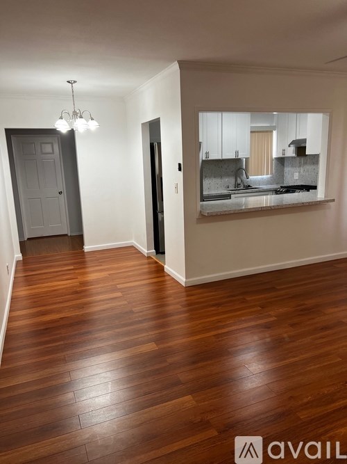 A room with wooden floors and a chandelier.