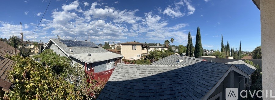 A house with a red roof is for sale.
