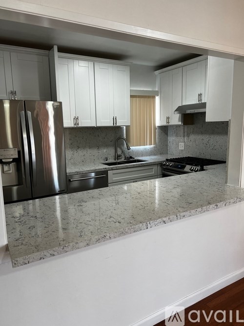 A kitchen with granite countertops and stainless steel appliances.